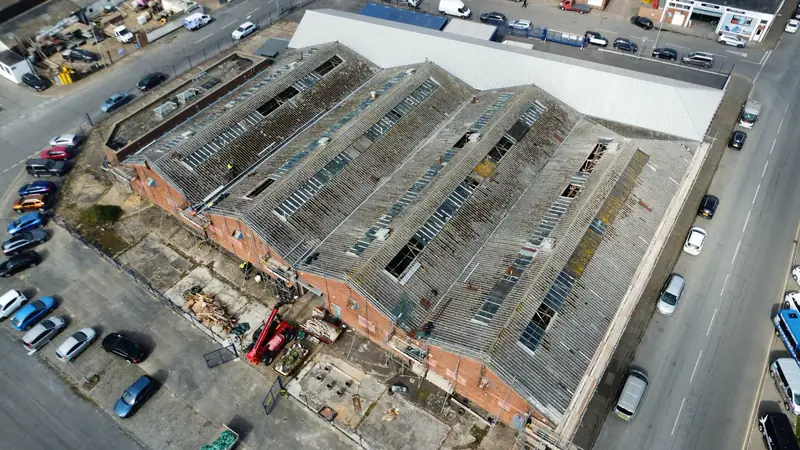 Large commercial industrial roof undergoing maintenance and re-roofing