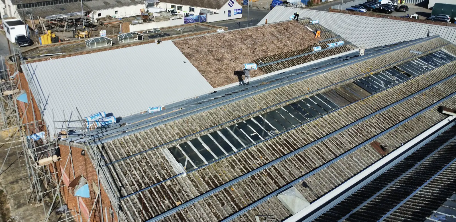 Asbestos cement roof being stripped and replaced with new metal sheeting by Over The Ridge Roofing