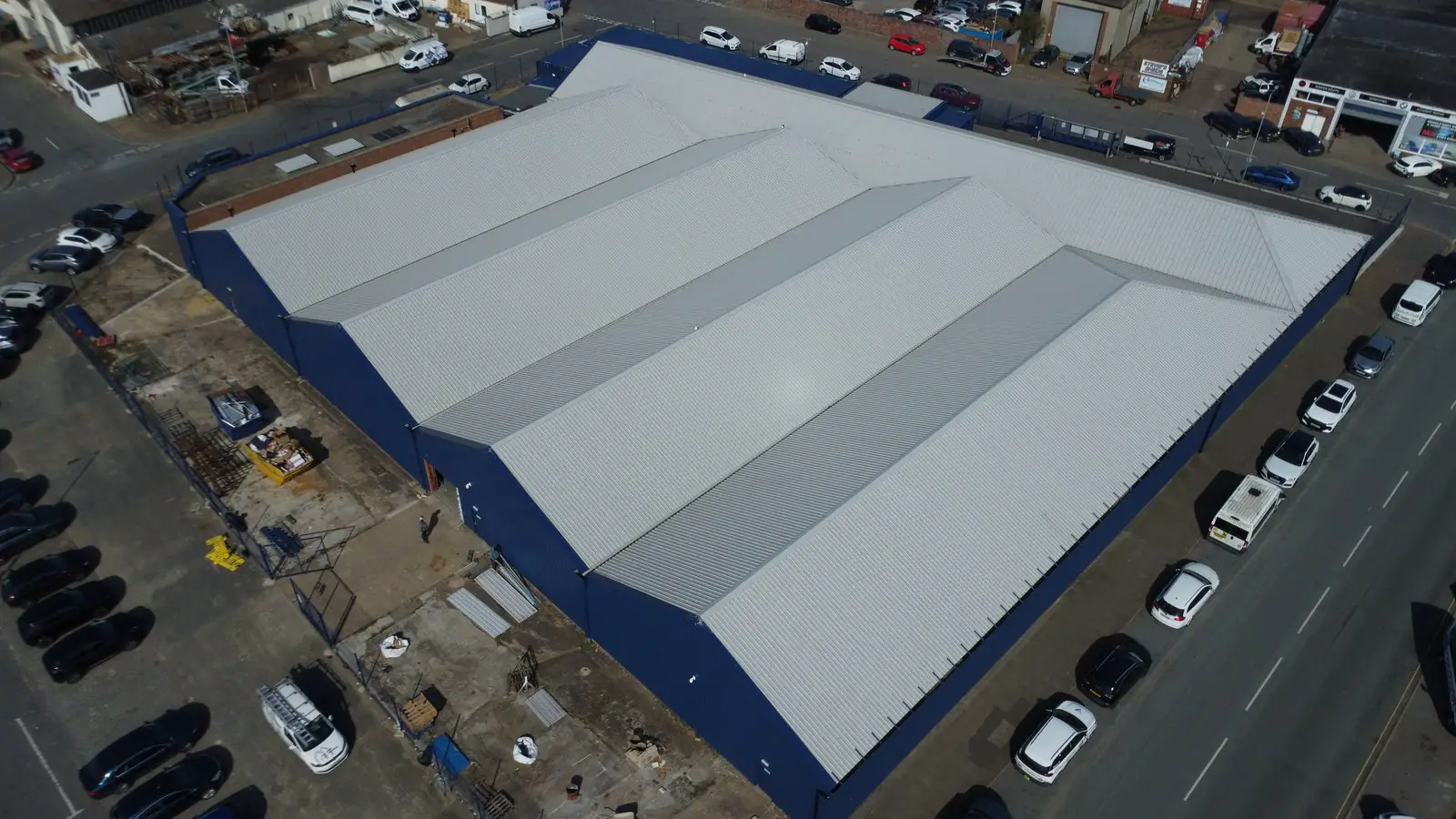 Aerial view of a large commercial industrial roof maintained by Over The Ridge Roofing
